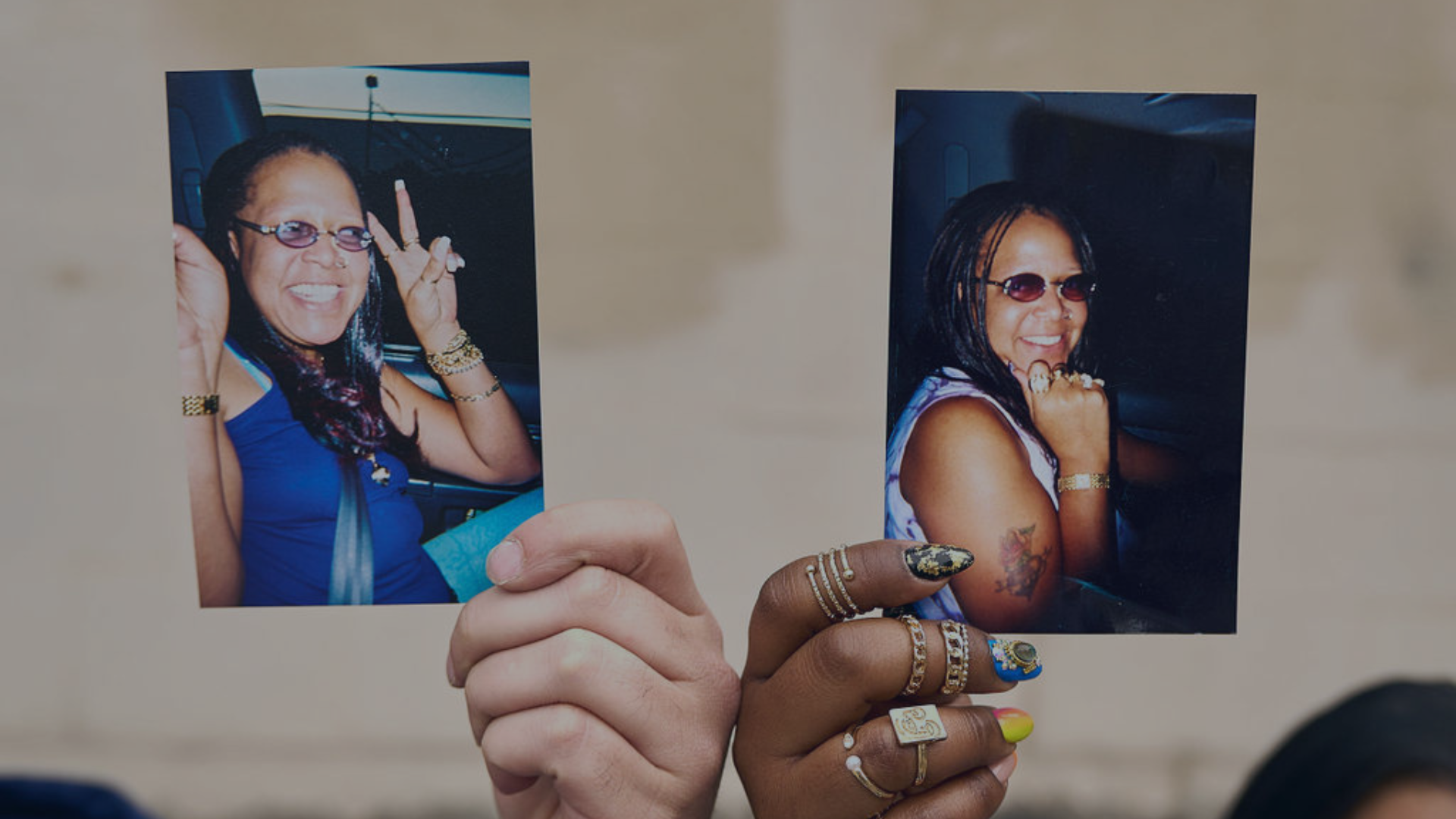 Two photos being held in the air by a brother and a sister